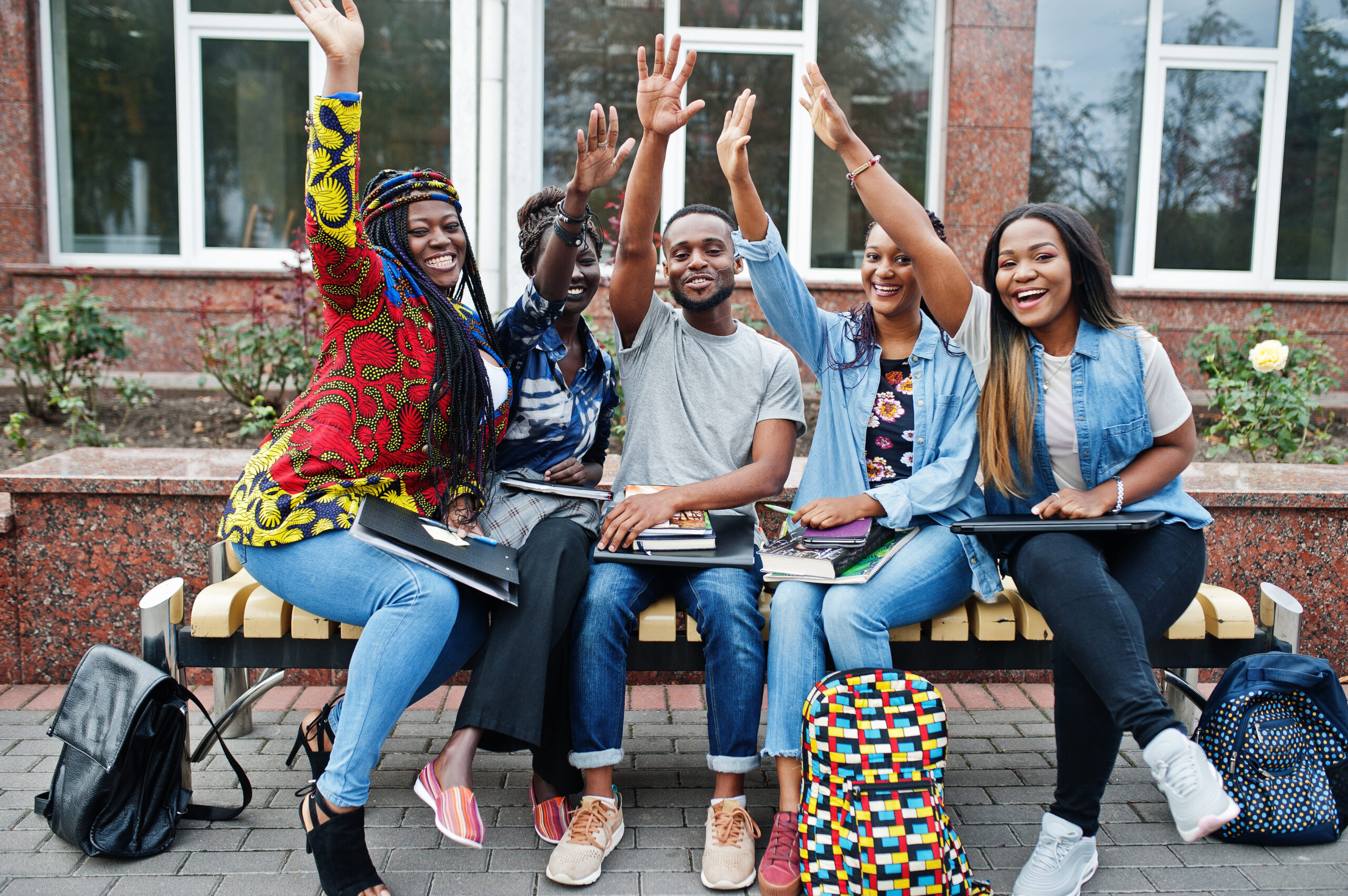 group five african college students spending time together campus university yard black afro friends studying bench with school items laptops notebooks (1)